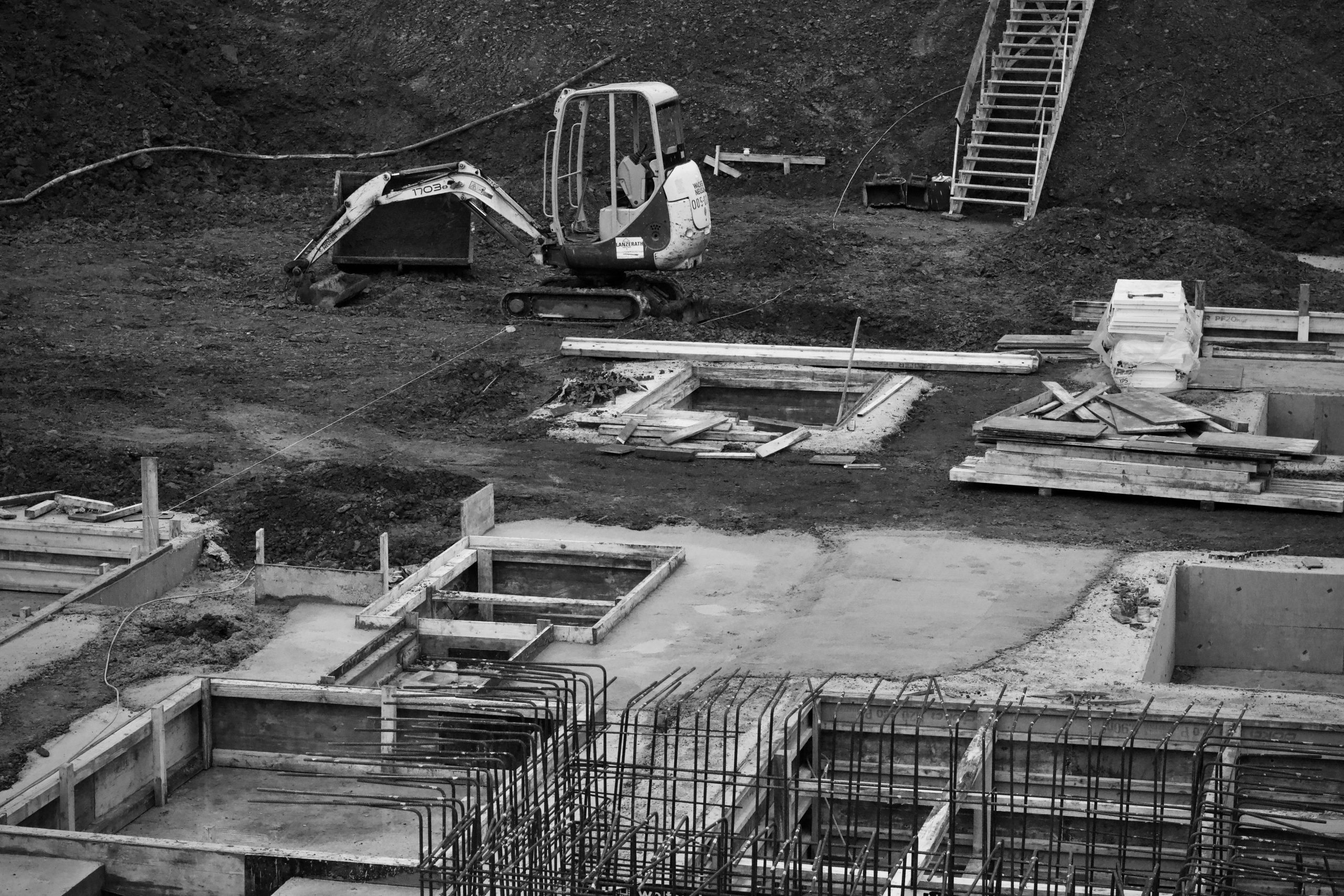 Excavatrice sur chantier avec fondations armees